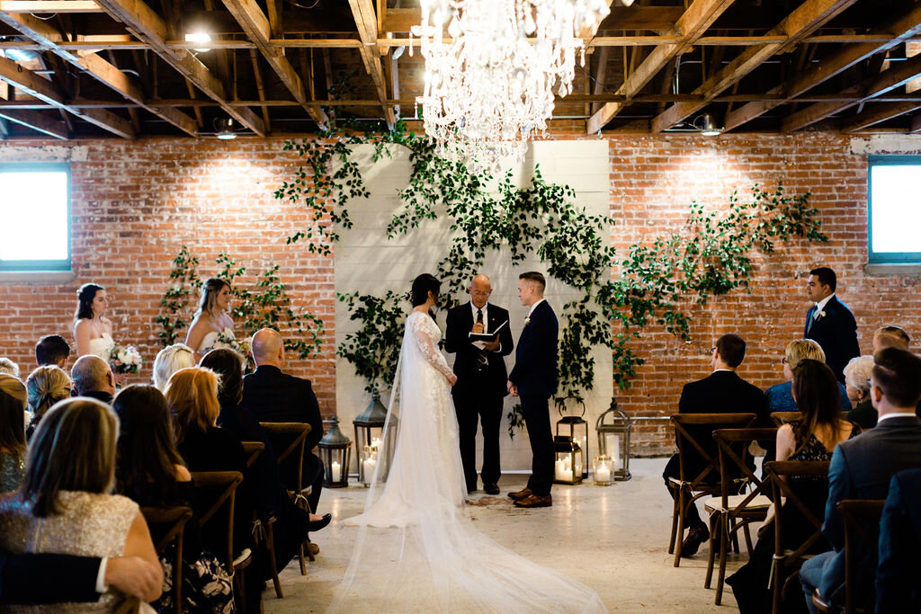 Abby + Justin’s winter wedding was warm and intimate surrounded by the closest friends, brick walls, greenery and plenty of candlelight!