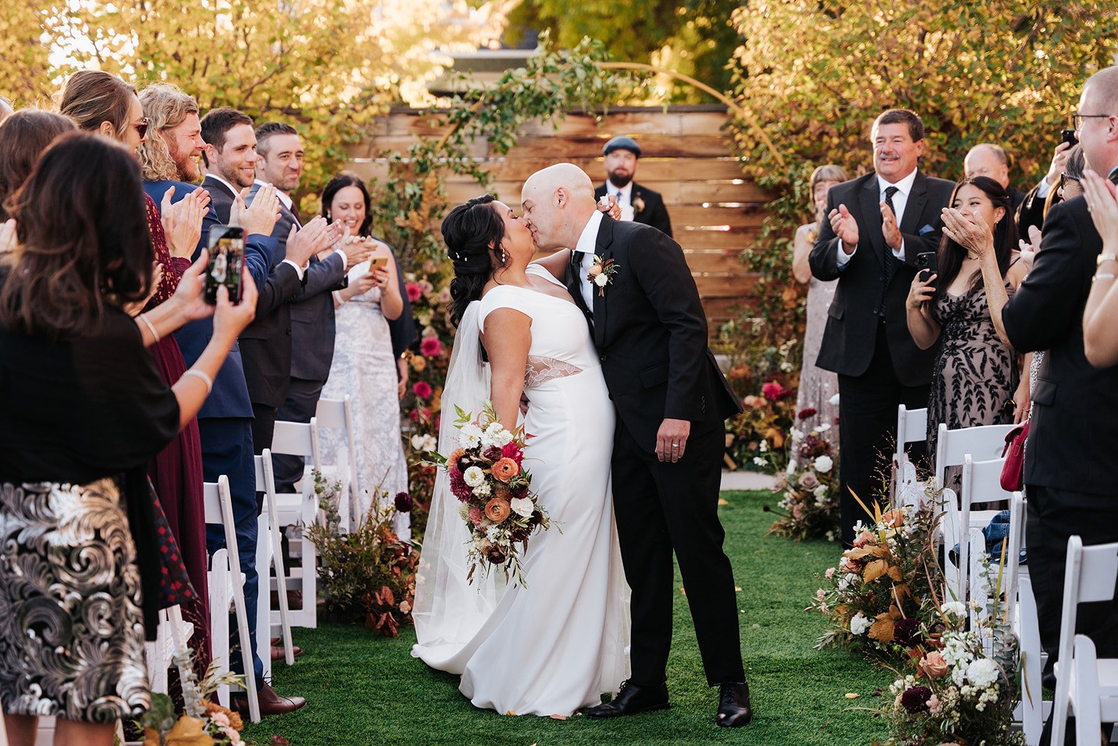 Bride and groom kissing after wedding ceremony in courtyard at the St Vrain wedding venue, Colorado
